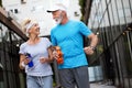 City running couple jogging outside. Senior couple runners training outdoors Royalty Free Stock Photo