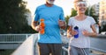 City running couple jogging outside. Senior couple runners training outdoors Royalty Free Stock Photo