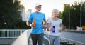 City running couple jogging outside. Senior couple runners training outdoors Royalty Free Stock Photo