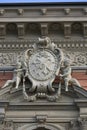 Facade decoration of the old mansion of Baron Stieglitz. Monogram nameplate held by two boys