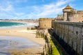 The city of Saint-Malo in Brittany seen from the surrounding wall of the old town with the towers of the castle, the breakwater
