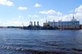 View of the Petrogradskaya embankment and the cruiser `Aurora` on a clear summer day.