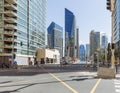 City scape with modern high-rise buildings, intersection and blue sky in background at Dubai