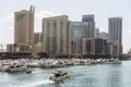 City scape with modern high-rise buildings, man made river with yachts and blue sky in background at Dubai Royalty Free Stock Photo