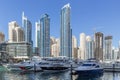 City scape with modern high-rise buildings, man made river with yachts and blue sky in background at Dubai Royalty Free Stock Photo