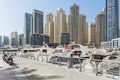 City scape with modern high-rise buildings, man made river with yachts and blue sky in background at Dubai