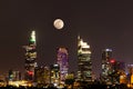 City Scene with The Moon Rising above Ho Chi Minh City's Central Business District by Night Royalty Free Stock Photo