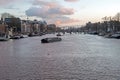 City scenic from Amsterdam at the Amstel in the Netherlands with the Tiny Bridge at sunset