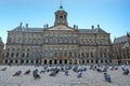 City scenic from Amsterdam on the Dam square with doves instead of tourists during the Corona crisis in the Netherlands Royalty Free Stock Photo