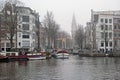 City scenic from Amsterdam in the fog with the Zuiderkerk in the Netherlands