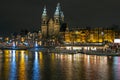 City scenic from Amsterdam in the Netherlands at night with the St. Niklaas church Royalty Free Stock Photo