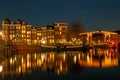 City scenic from Amsterdam at the river Amstel  in the Netherlands at night Royalty Free Stock Photo