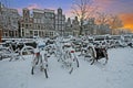 City scenic from snowy Amsterdam in Netherlands at sunset Royalty Free Stock Photo