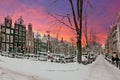 City scenic from snowy Amsterdam the Netherlands at sunset Royalty Free Stock Photo