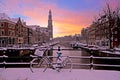 City scenic from snowy Amsterdam with the Westerkerk in Netherlands at sunset Royalty Free Stock Photo