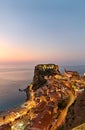 The city of Scilla Calabria Italy. Elevated view of the illuminated Ruffo castle at sunset