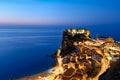 The city of Scilla Calabria Italy. Elevated view of the illuminated Ruffo castle at sunset