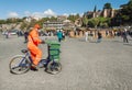 City service worker in uniform cleans the street from garbage on a bicycle Royalty Free Stock Photo