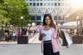City shopping girl with shopping bags and mobile phone in her hand in Canary Wharf, London Royalty Free Stock Photo