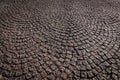 City sidewalk paved with cobblestone, natural stone background