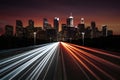 City silhouette with headlamp trails on road captures urban vibrancy