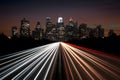 City silhouette with headlamp trails on road captures urban vibrancy
