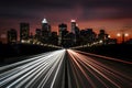 City silhouette with headlamp trails on road captures urban vibrancy