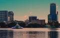 City skyline and colorful water fountain at sunset in Lake Eola Park. Royalty Free Stock Photo