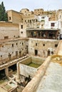 City skyline, drying hides and dye pots at one of the tanneries