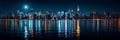 A city skyline lit up at night with a full moon in the sky Royalty Free Stock Photo