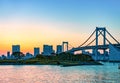 City skyline and Rainbow bridge across Tokyo Bay in sunset. Odaiba, Tokyo, Japan Royalty Free Stock Photo