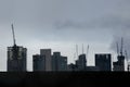 City skyline silhouette of skyscrapers under construction with cranes Royalty Free Stock Photo