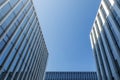 City skyscrapers bottom view against blue sky. Low wide angle shot, from ground. Glass facade Architecture exterior. Royalty Free Stock Photo