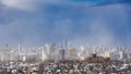 City in a snowy storm against the backdrop of sunlight