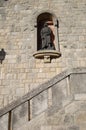 The city is the state of San Marino, the figure of the saint in a niche in the wall of the building.