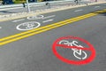 City street asphalt road with separated two way direction bicycle lane route sign mark and bike riding prohibited symbol