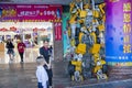 City street, boy looks at the transformer robot near the entrance to the supermarket