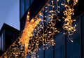 City street Christmas decoration. electric garlands with big North Star on the background of the facade of a modern building Royalty Free Stock Photo