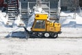 City street cleaned from snow by a snowplough