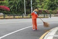 City street cleaners in special clothes with panicles and straw hats 