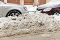 City street driveway parking lot with many cars covered by snow stucked after heavy blizzard snowfall on winter day by Royalty Free Stock Photo