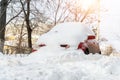 City street driveway parking lot spot with small car covered snow stuck trapped after heavy blizzard snowfall winter day Royalty Free Stock Photo