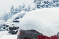 City street driveway parking lot spot with small car covered snow stuck trapped after heavy blizzard snowfall winter day Royalty Free Stock Photo