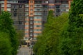 City street green urban landmark view trees foliage foreground and vintage style building architecture facade exterior background Royalty Free Stock Photo