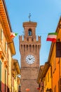 City street with houses, tower and Italian flag Royalty Free Stock Photo