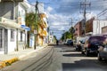 City street with multiple cars parked along the side in Cozumel, Maxico