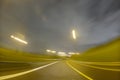 CITY STREET AT NIGHT WITH MOTION BLURRED LIGHTS OF FAST MOVING CARS, MODERN CITYSCAPE, RUSH ON THE STREET Royalty Free Stock Photo