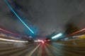 CITY STREET AT NIGHT WITH MOTION BLURRED LIGHTS OF FAST MOVING CARS, MODERN CITYSCAPE, RUSH ON THE STREET Royalty Free Stock Photo