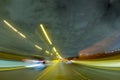 CITY STREET AT NIGHT WITH MOTION BLURRED LIGHTS OF FAST MOVING CARS, MODERN CITYSCAPE, RUSH ON THE STREET Royalty Free Stock Photo