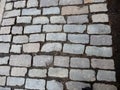 City street paved with colorful cobblestones pavement with ground between tiles